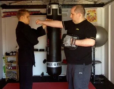 Blind Shodan Sensei Mark Brown explaining karate Bunkai to Robert Poelcat.