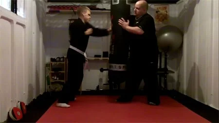 Self defense training in the MMA Dojo, Mark Brown hits the punch bag.